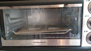 A toaster oven is your friend if you want to easily peek and yank out Shrinky Dinks